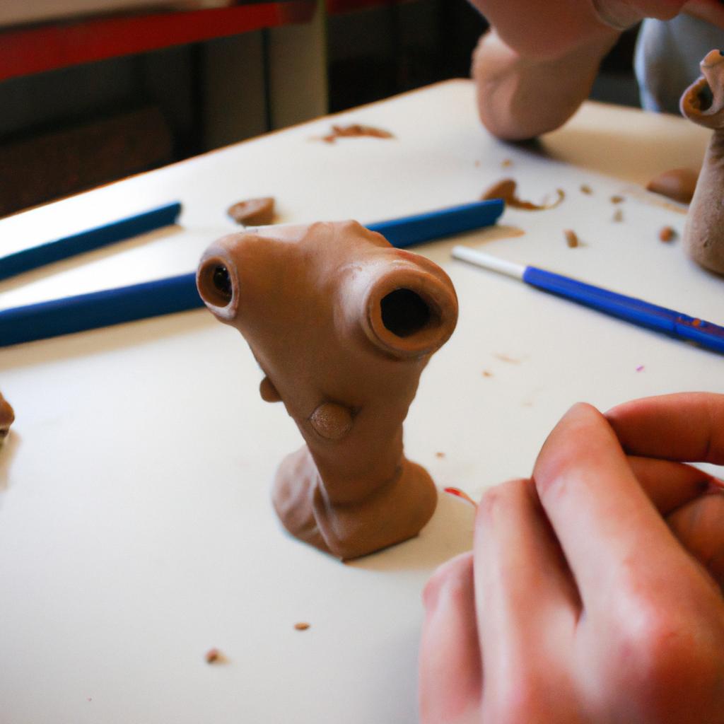 Person sculpting a clay figure